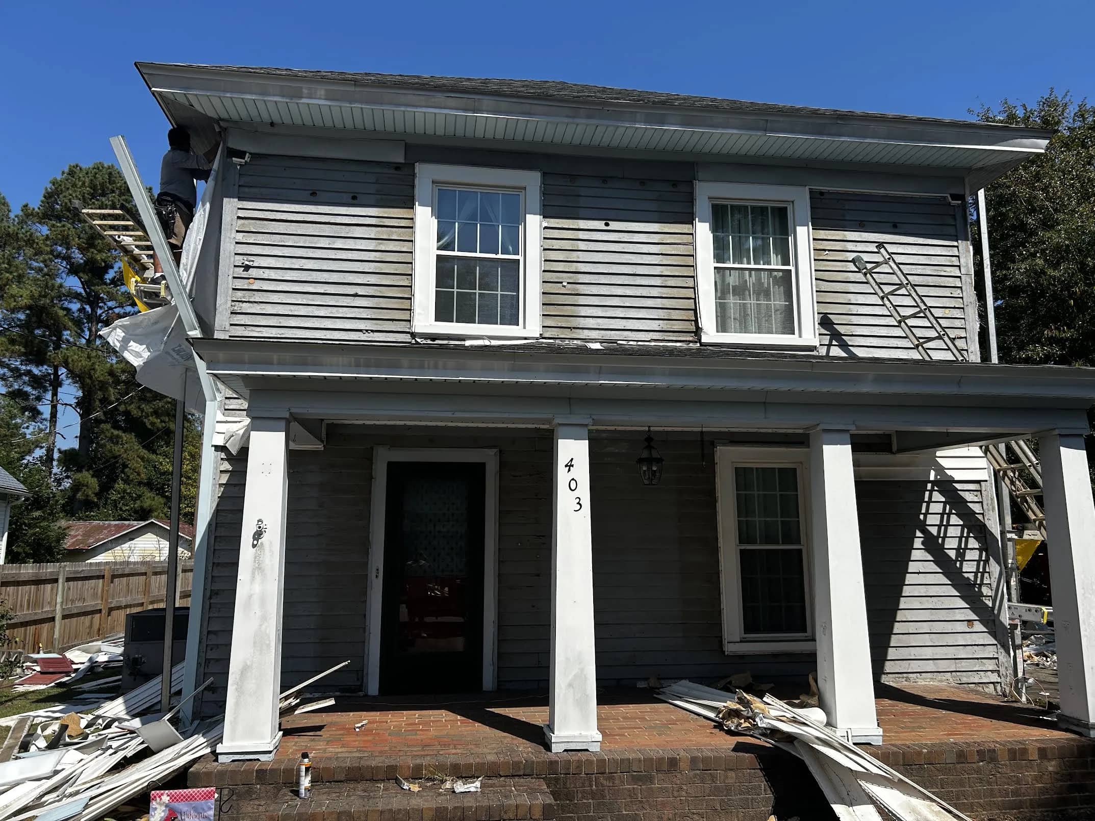 From worn gray to deep blue — exterior before siding work.