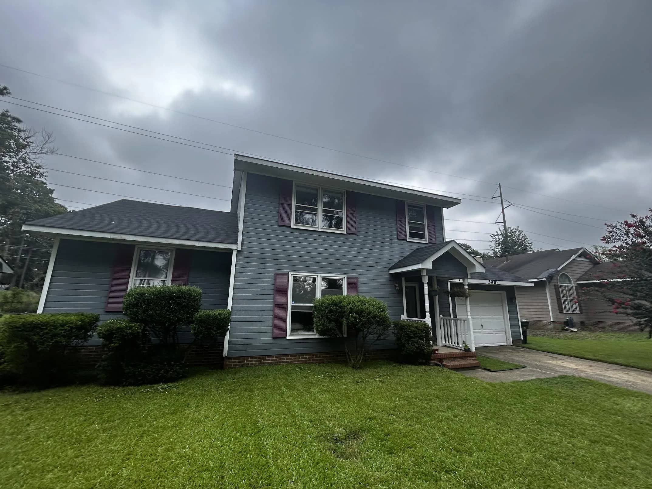 Dark gray siding on the home before its exterior renewal.