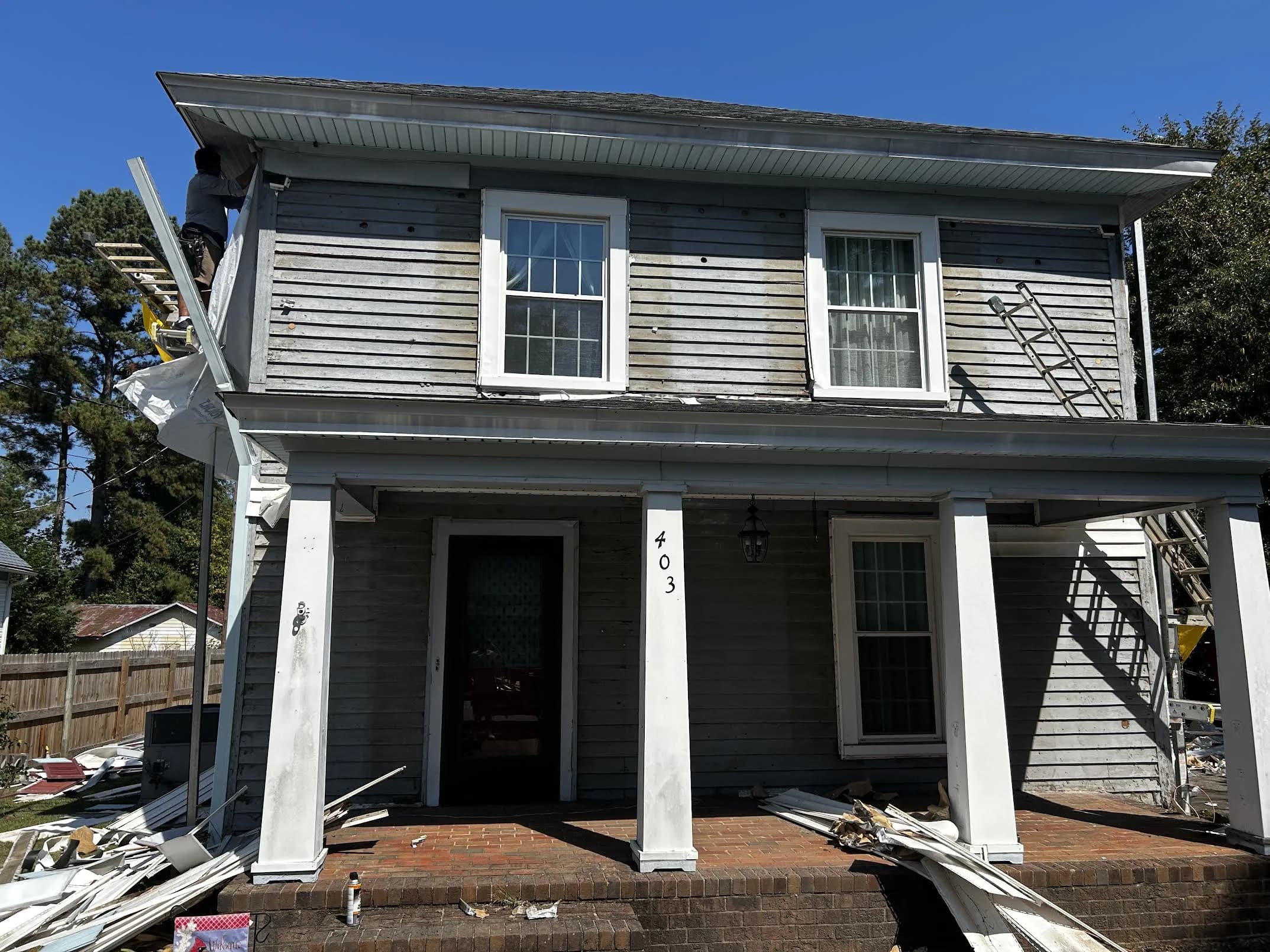 From worn gray to deep blue — exterior before siding work.