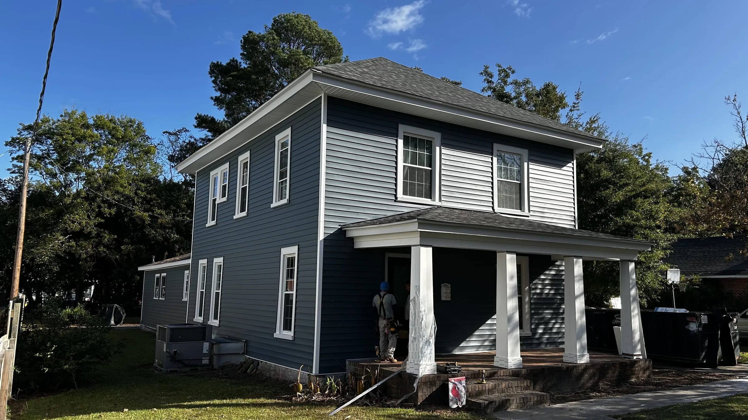 Blue-gray siding and white trim on a home being finished by the FFC crew.