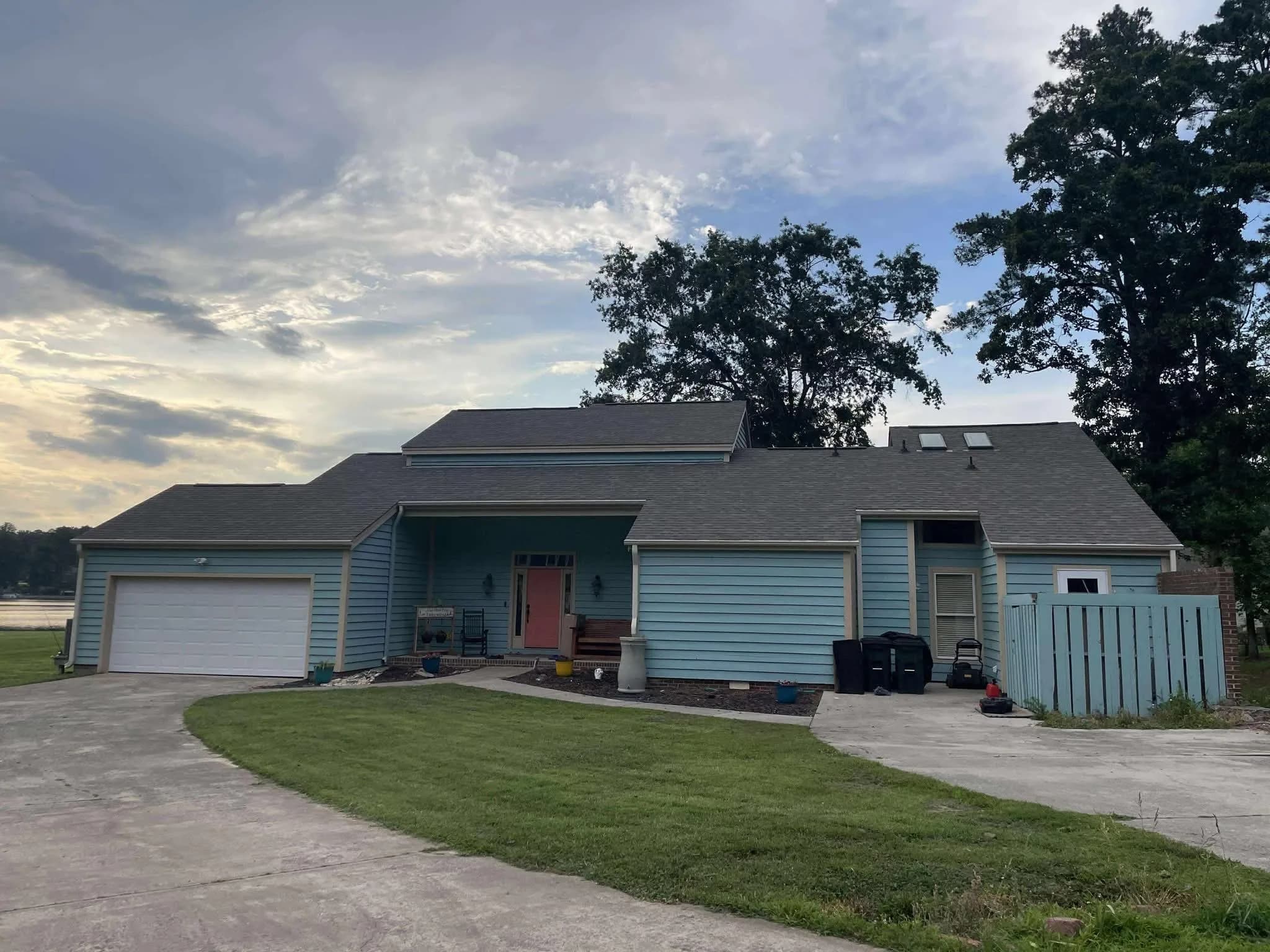 A blue siding transformation — exterior before siding work.